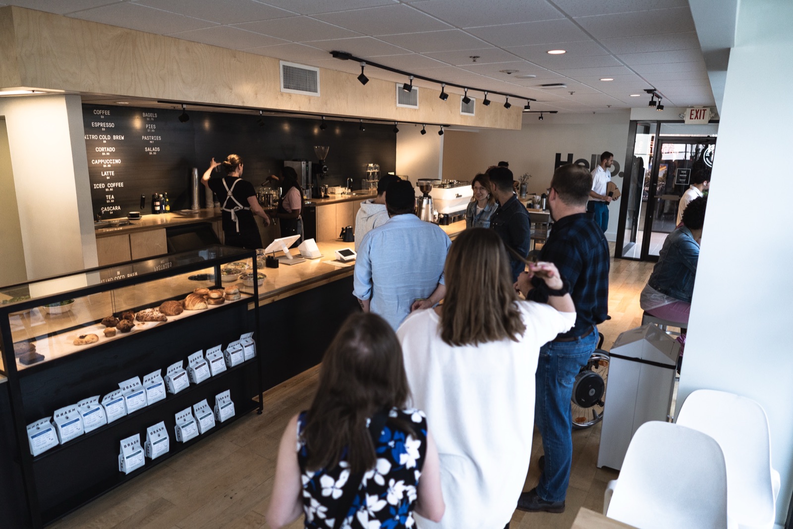 Customers lining up at the Huge Café counter during a busy service