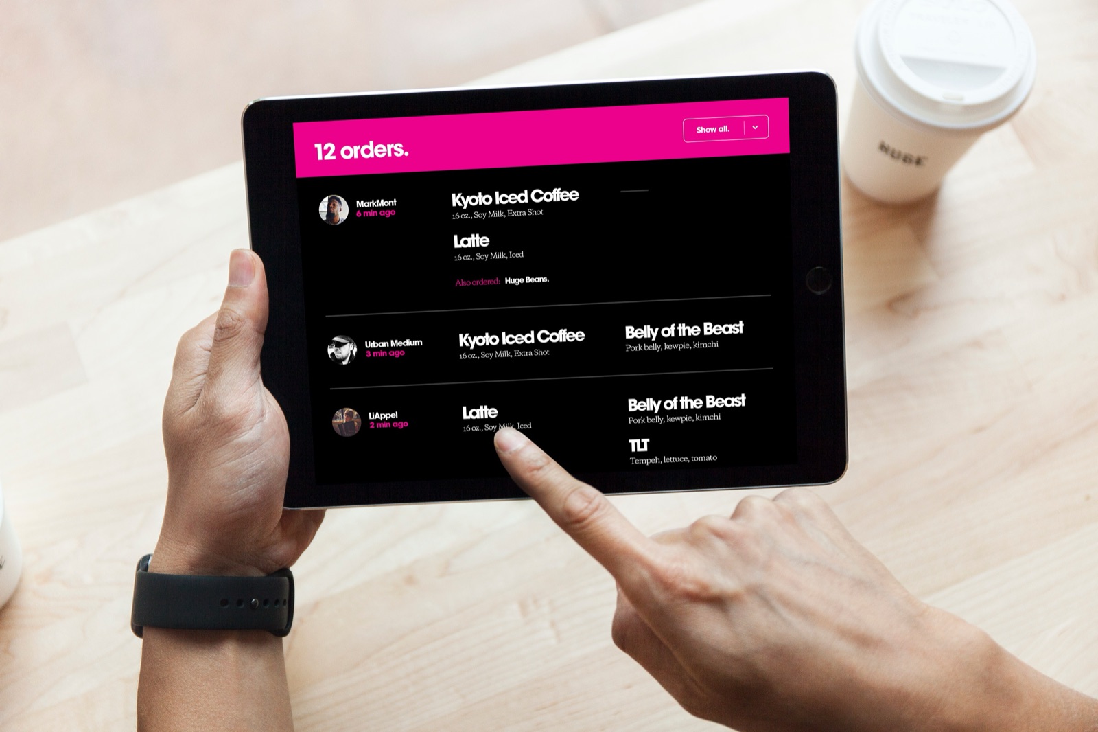 Barista managing incoming orders on the custom iPad application